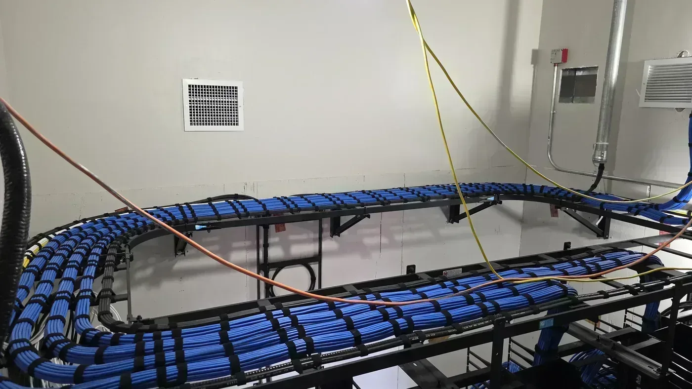 Dressed Cat6A cable bundles on ladder rack in parking structure TDR